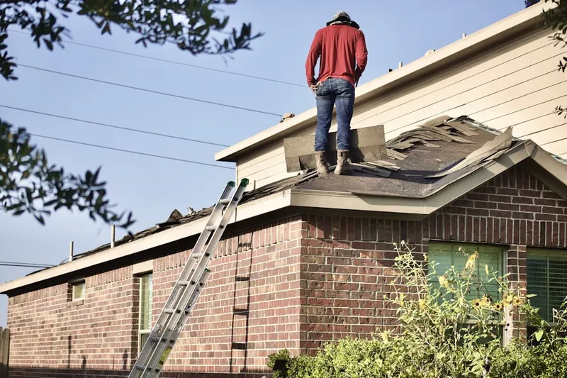 Professional roofer working on a residential roof in Joyner